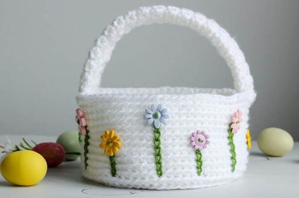 crocheted basket in white with flower buttons and surface crochet 