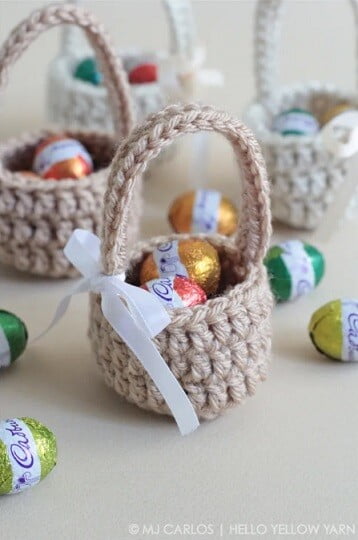 mini baskets with a ribbon on the handle and filled with mini eggs