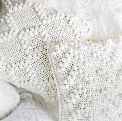 close up of bobble stitches creating diamonds and arrows on a pillow cover