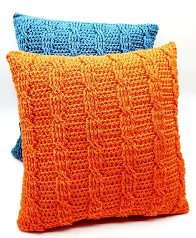 A pillow in light blue and a pillow in orange