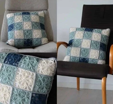 Two chairs have pillows on and a blanket made from the same granny squares is over the arm of a sofa