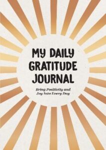 book cover for My Daily Gratitude Journal. The title of the book is in black in the middle of the cover with gold spokes from the centre to the edges