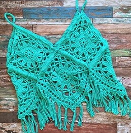 crocheted boho tank top is laid out on the floor