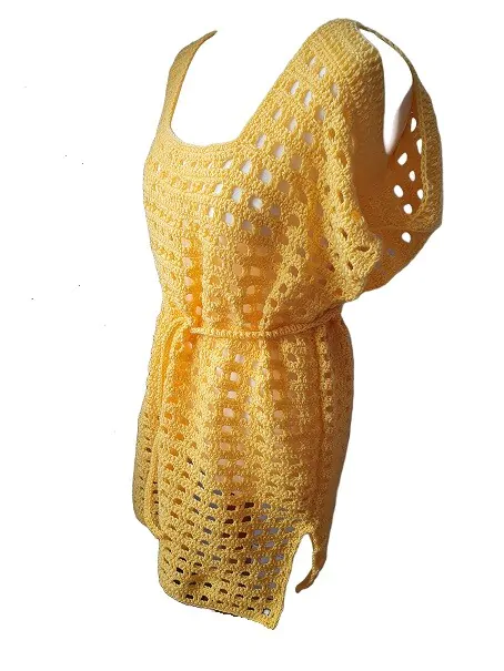 A sideways view of a yellow crochet beach dress