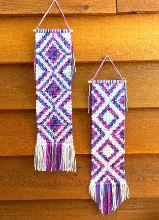 Tapestry crochet is used to create the diamond shapes in purple and white in this wall decor