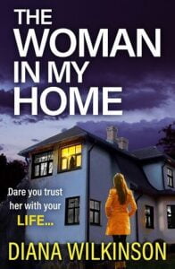 Book cover for The Woman in my Home by Diana Wilkinson. It is dusk. A woman in an orange coat is standing outside a house and looking up at a lit upstairs window with the silhouette of a person behind the window