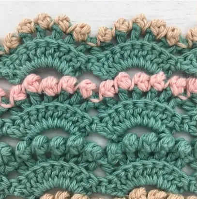 An edging crocheted in berry stitch