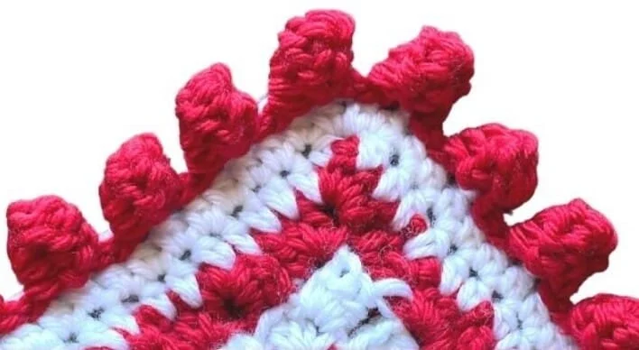A corner of a blanket showing the bobble stitch border