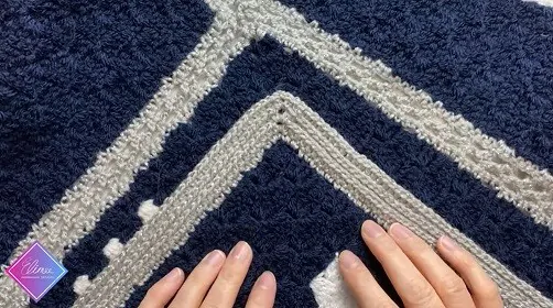 hands resting on a blanket