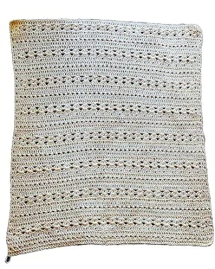 The back of a crochet cardigan laid flat