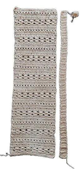 Front panel of a crochet cardigan laid flat next to the ribbed edging