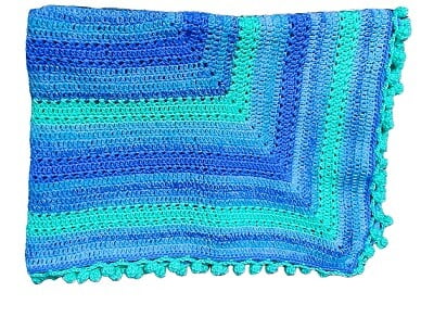 a crochet blanket folded in half