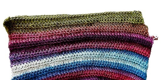 close up of a crochet hood showing where to sew seams along the top and down the side to the stitch marker