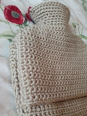 side view of a hot water bottle showing the envelope closure of the cover