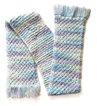 A crochet scarf is laid out in a zig zag