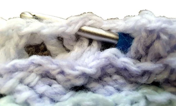 The skipped stitches for the Celtic Weave are hidden behind the worked stitches