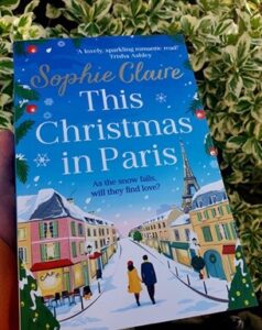 Book cover for This Christmas in Paris by Sophie Claire. A vector of a snowy street and a couple walking down the middle of the road