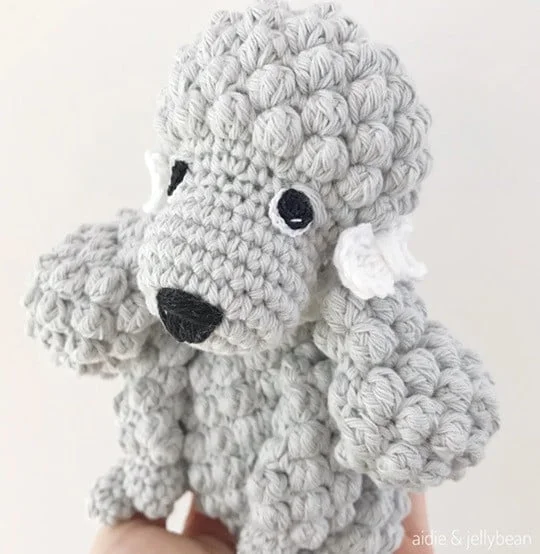 A poodle is crocheted in light grey