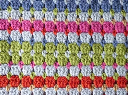 A close up of the crochet block stitch in various colours