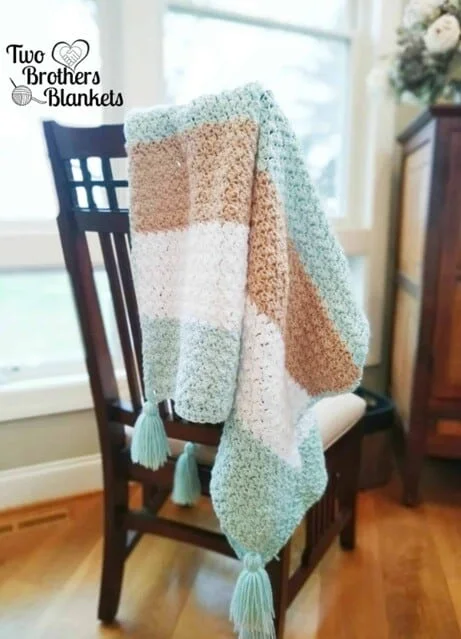 A blanket is draped over the back of a dining chair