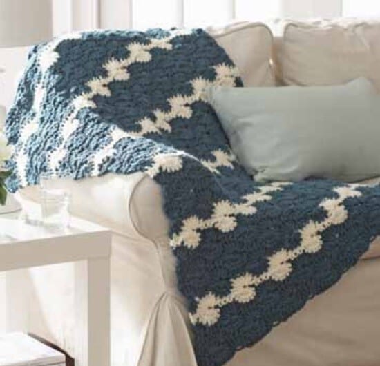 A blanket is styled on a sofa