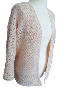 A cardigan crocheted in the block stitch is styled on a mannequin