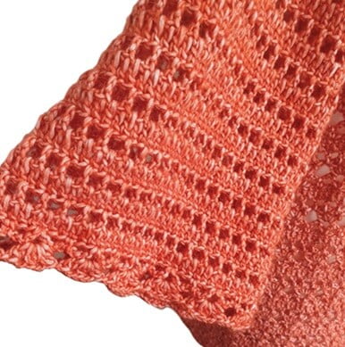 close up of a crochet sleeve with a lacy cuff