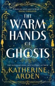 book cover for The Warm Hands of Ghosts by Katherine Arden. A deep blue background has the title of the book in the middle with author underneath