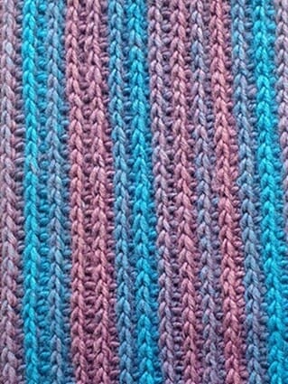 close up of knit-look crochet stitch in blues and browns