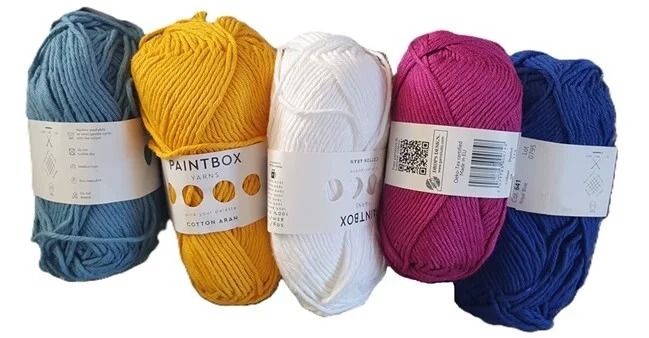 5 balls of cotton aran/worsted weight yarn in light blue, yellow, white, maroon and dark blue