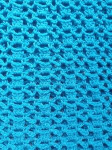 close up of the open stitch used in the ruana crochet pattern