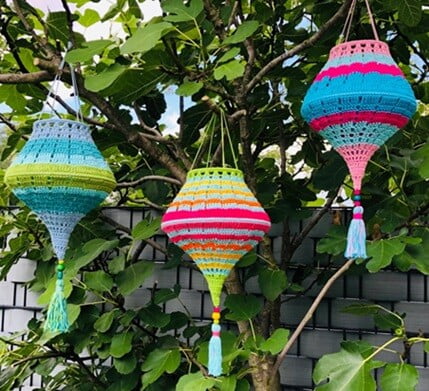 3 colourful lampions are hanging from a tree
