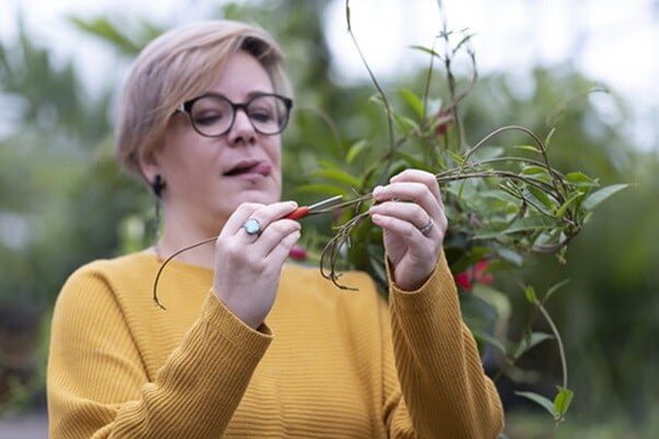 Crochet Designer Julie Desjardins is holding up crochet