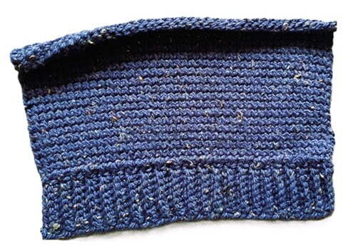rectangle of crocheted fabric ready to be assembled to make a hat