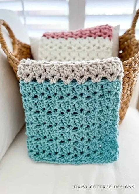 A throw is draped over a large basket