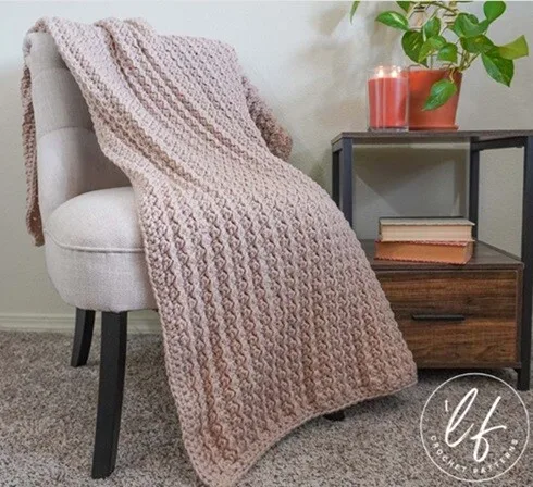 A large blanket is draped over a chair
