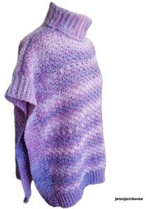 A cowl neck poncho in different shades of lavender is styled on a mannequin showing the side view