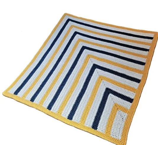 Striking stripes in blue, yellow and white in a blanket worked on the bias