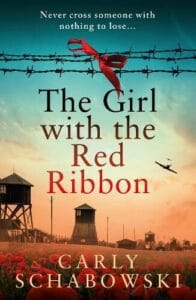 Book cover for The Girl with the Red Ribbon by Carly Schabowski. A red ribbon is tied around the barbed wire that is surrounding a concentration camp