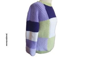 A colourful patchwork sweater is styled on a mannequin