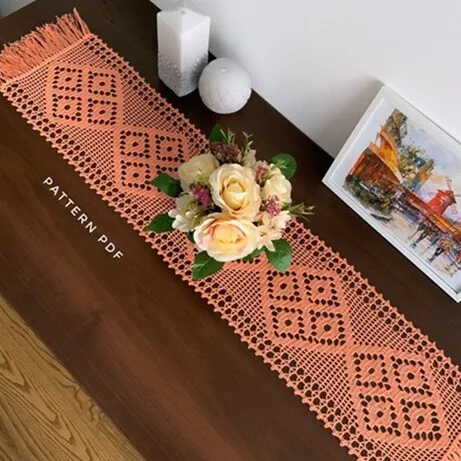 Filet crochet is used to create this elegant table runner with intricate openwork.