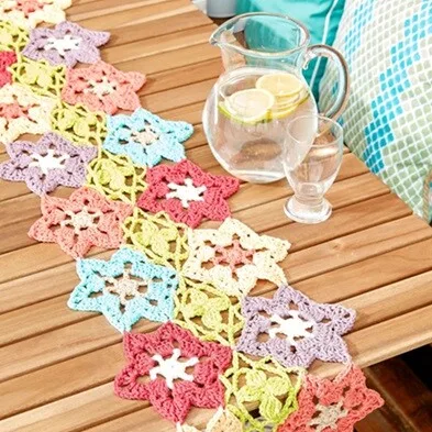 bright flowers are linked together to complete this delicate runner