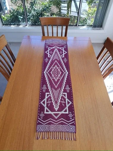 A mosaic crochet design creates a visually appealing table runner