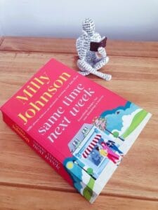 book cover for Same Time Next Week by Milly Johnson. 3 women are walking away from a diner. An outline of a person inside the diner is sat on their own