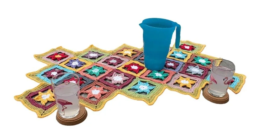 Floral granny squares are joined together to form an asymmetrical table runner