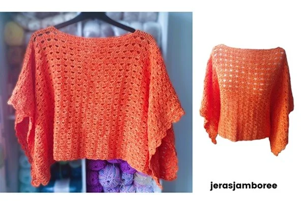 A crochet poncho in a vibrant orange shade is displayed in two images. The left image shows the poncho hanging on a black hanger against a background of yarn-filled shelves, featuring an openwork stitch pattern and a wide boat neckline. The right image presents the same poncho on a plain white background, highlighting its airy texture and draped sleeves.
