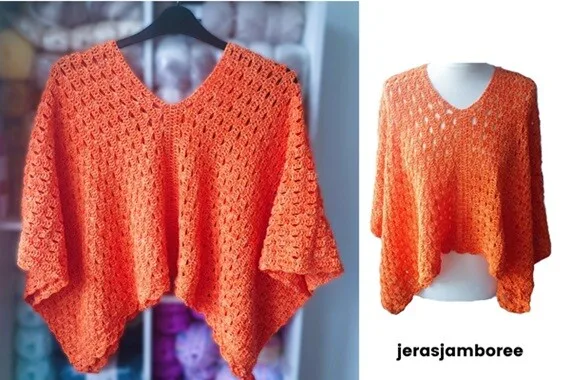 An orange crochet poncho is displayed in two images, highlighting its intricate openwork design. The left image shows the poncho hanging on a black hanger against a yarn-filled background, featuring a V-neckline and a pointed hem. The right image presents the poncho on a mannequin with a white background, emphasizing the drape and airy texture.