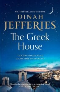 Book cover of The Greek House by Dinah Jefferies, featuring a twilight view of a Greek coastal village with whitewashed buildings under a starry sky and crescent moon. The tagline reads, “Can one house hold a lifetime of secrets?” and a quote at the bottom praises it as “Absolutely sumptuous ... a stunning novel” — Santa Montefiore.
