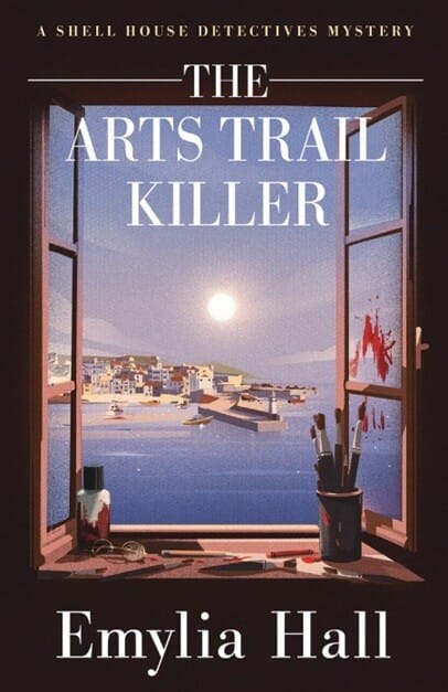 Book cover for The Arts Trail Killer by Emylia Hall, part of “A Shell House Detectives Mystery” series. The artwork shows an open window overlooking a seaside village under a full moon, with calm blue water and boats in the harbor. Inside the window frame are art supplies and paintbrushes, with red paint smeared ominously on the right window pane, suggesting a crime scene.