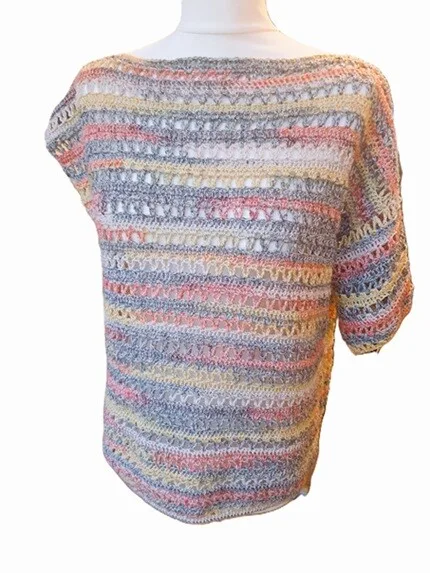 The Orla Crochet Pullover displayed on a mannequin with one sleeve shortened. The image showcases the lightweight drape and striped stitch pattern in soft pastel tones, highlighting a customisable sleeve option. The background is white, placing full focus on the garment.